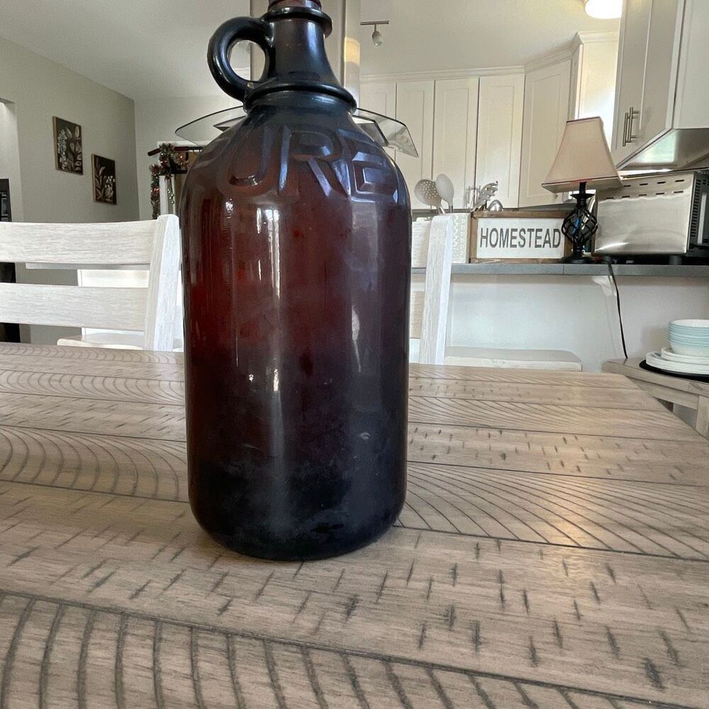 Vintage Amber brown glass Purex bleach bottle with single finger loop hole